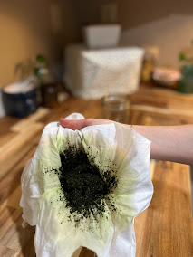 piece of muslin fabric straining loose herbs into a bowl
