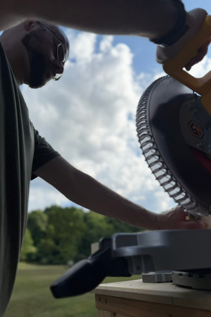 Man operating a miter saw power tool